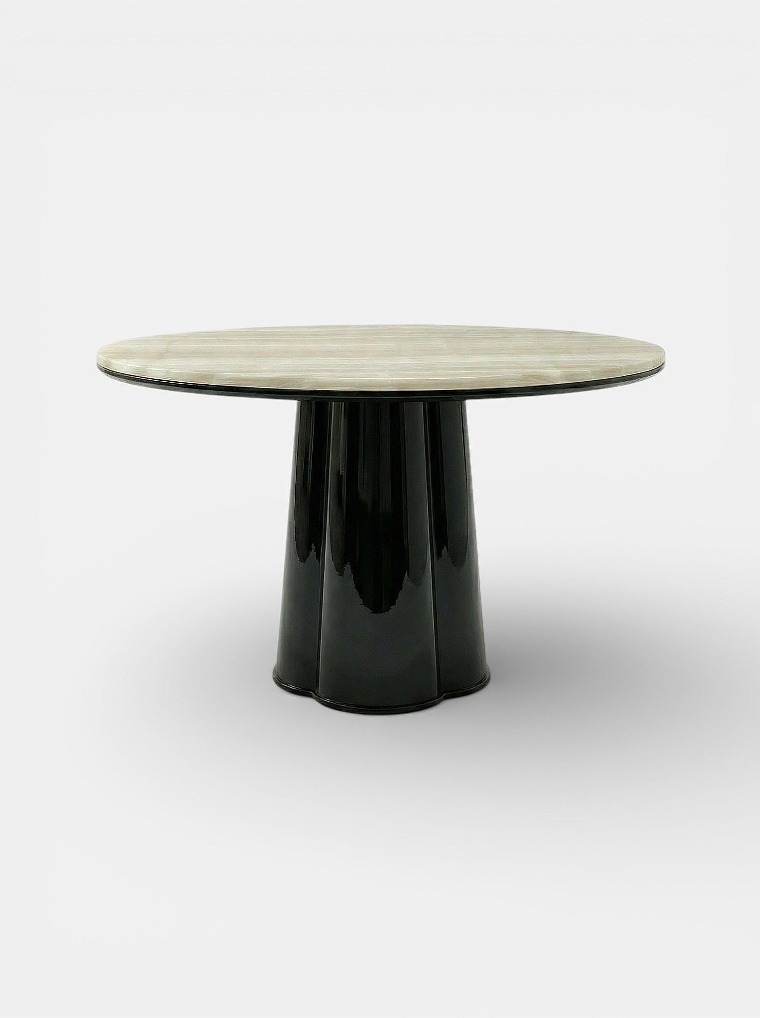 Side angle view of Poli luxury dining table featuring black lacquered finish and ivory onyx marble