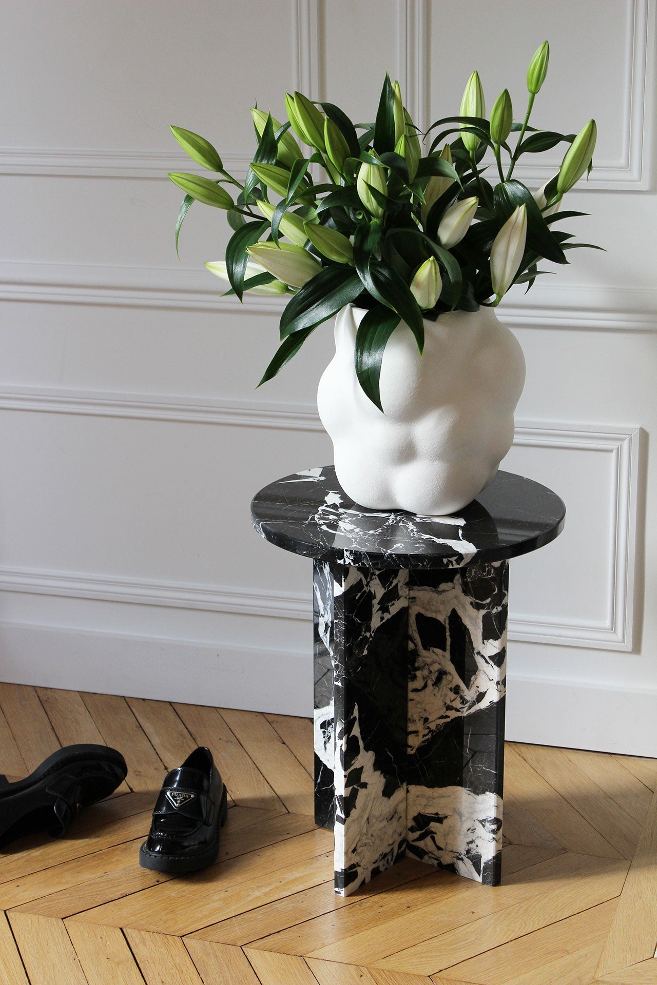 Detail view of Rosie Grand Antique marble table showing natural stone patterns and elegant round silhouette