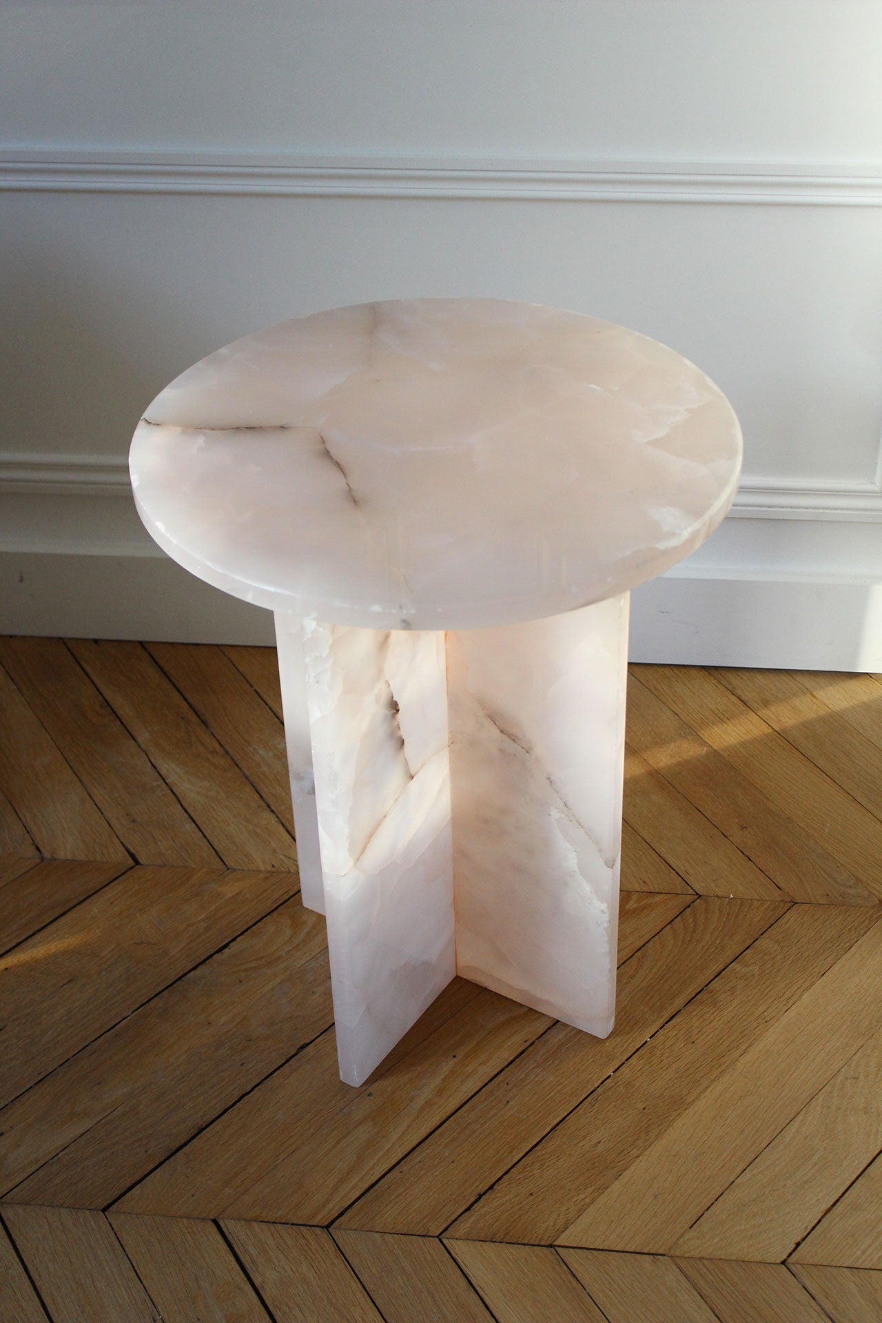 Top view detail of pink onyx Rosie table surface revealing natural stone patterns and marble craftsmanship