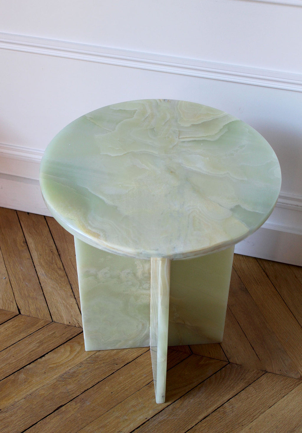 Close-up detail of green onyx Rosie table surface showing beautiful natural stone patterns and translucency