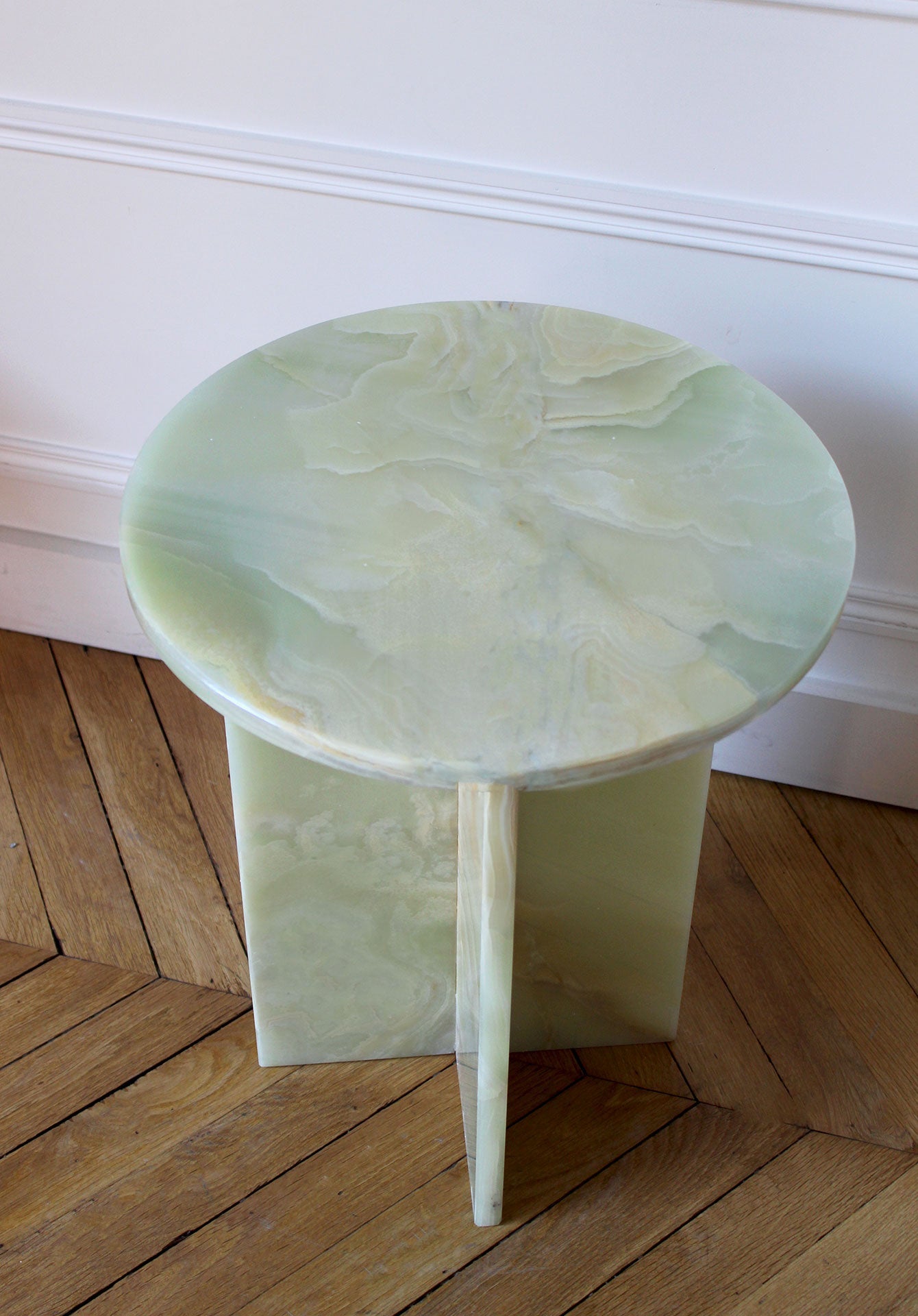 Close-up detail of green onyx Rosie table surface showing beautiful natural stone patterns and translucency