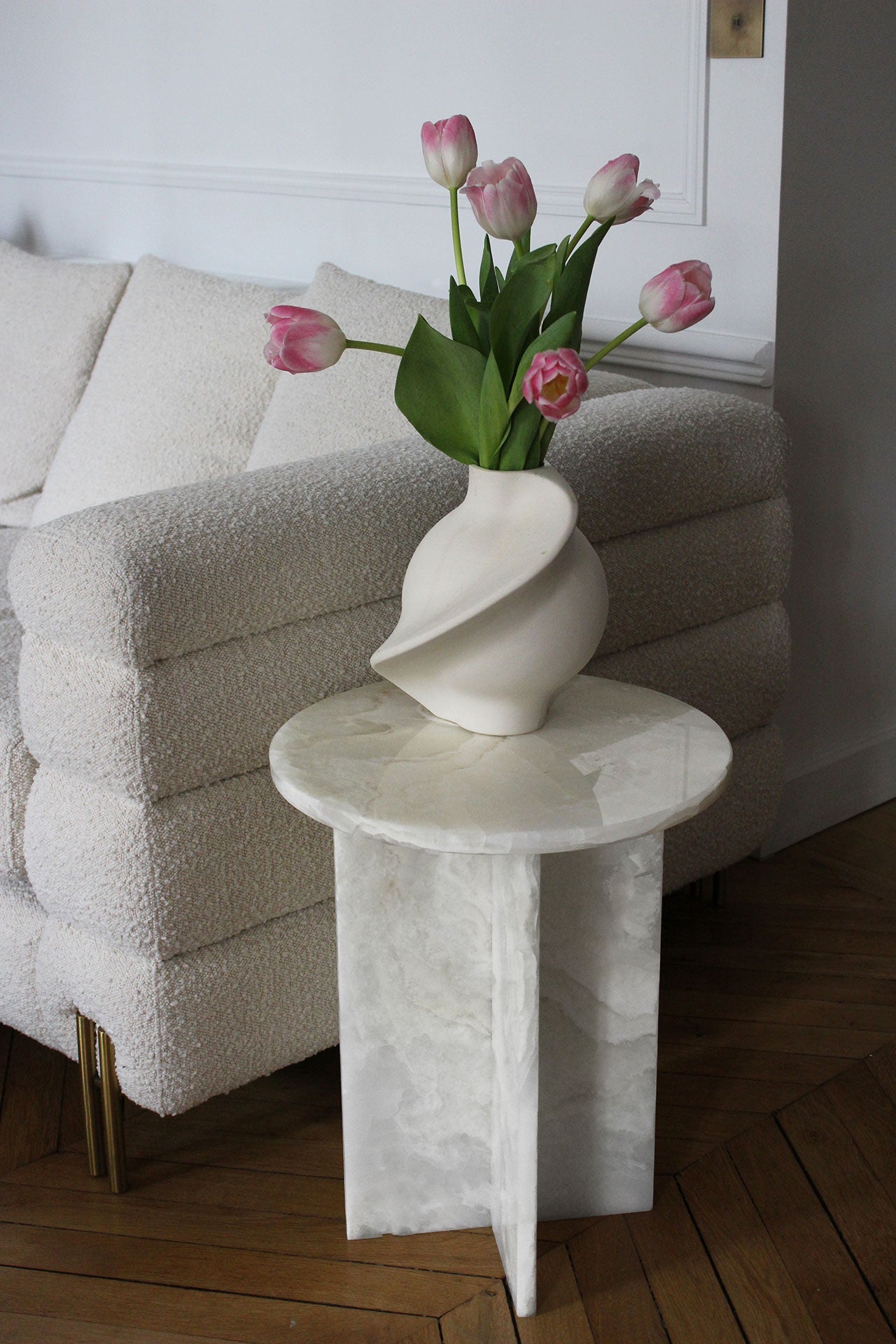 White onyx Rosie table styled with flowers showcasing elegant proportions and natural marble beauty