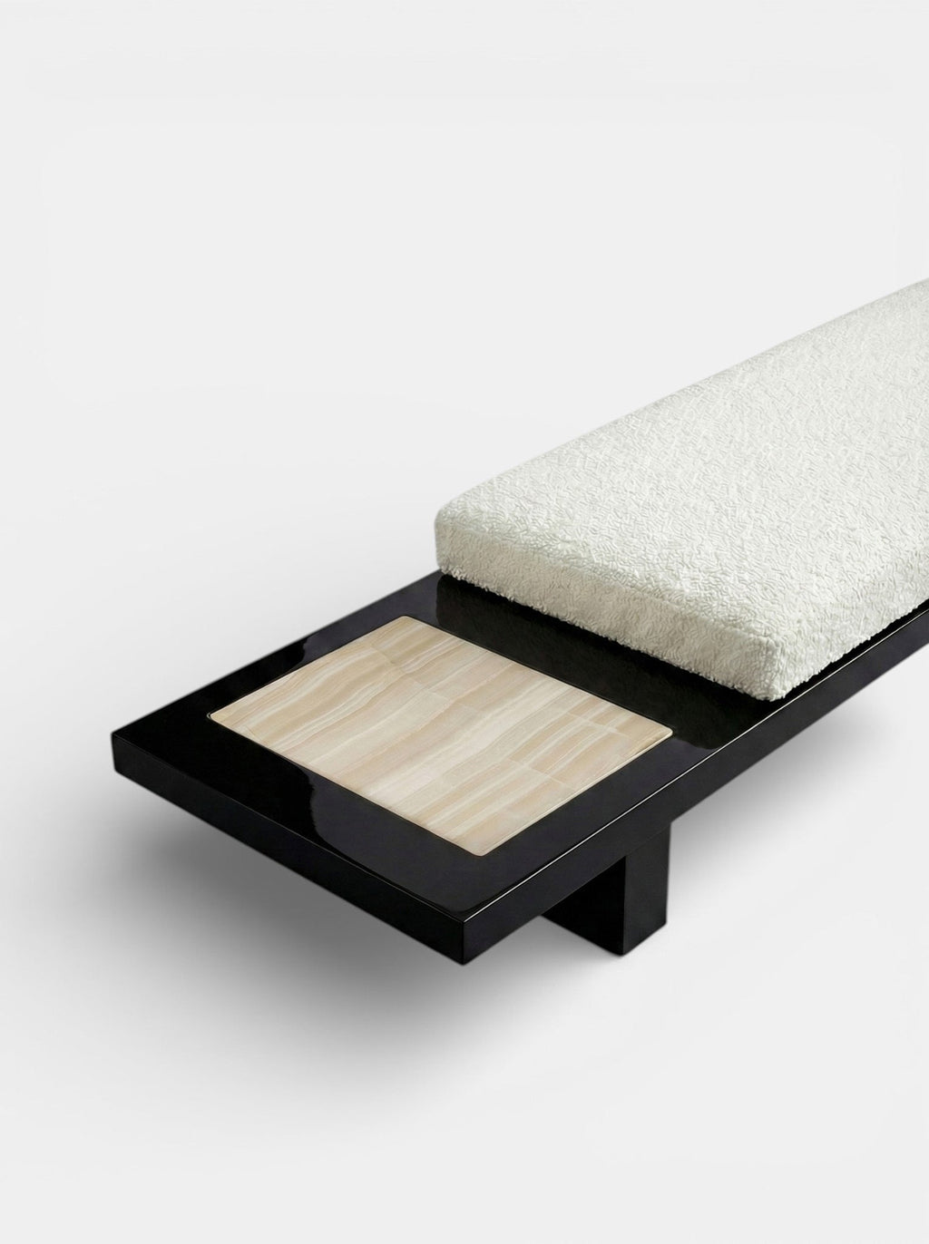 Side profile of Sybille black ivory onyx bench showcasing dramatic marble patterns and sculptural form
