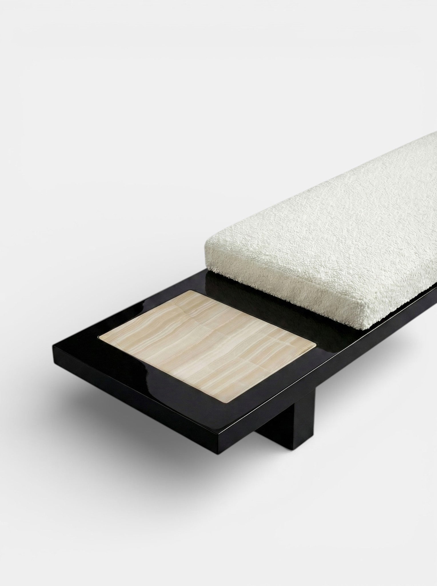 Side profile of Sybille black ivory onyx bench showcasing dramatic marble patterns and sculptural form