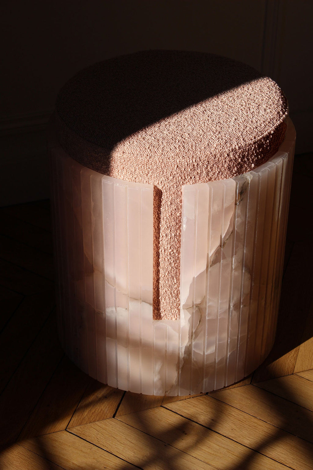 Luxury pink onyx Dolce stool detail - Italian marble craftsmanship close-up texture surface